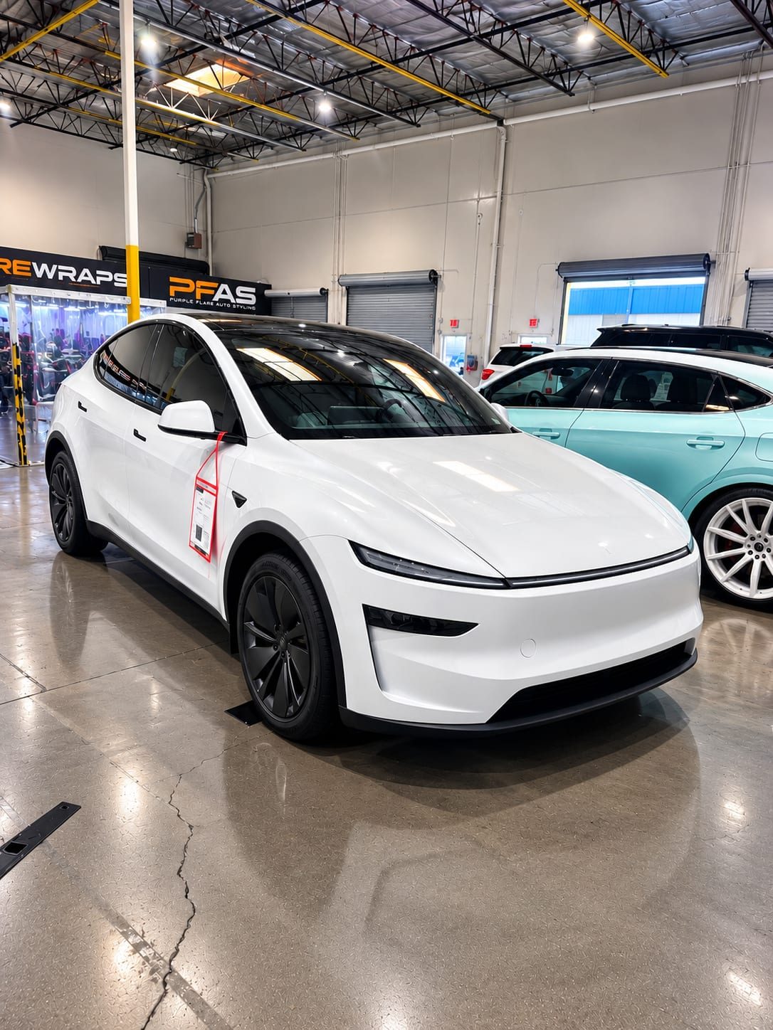 White Tesla Model Y With Ceramic Window Tint In The Shop